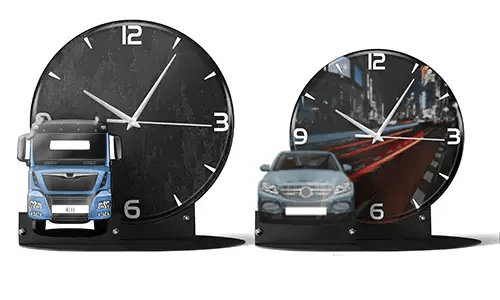 Two decorative clocks with model vehicles: left with black marble face and blue truck, right with cityscape and red sports car