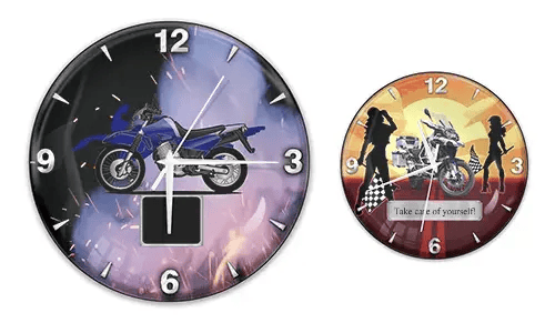 Two wall clocks with motorcycle themes: left with blue bike and flame background, right with white bike and sunset