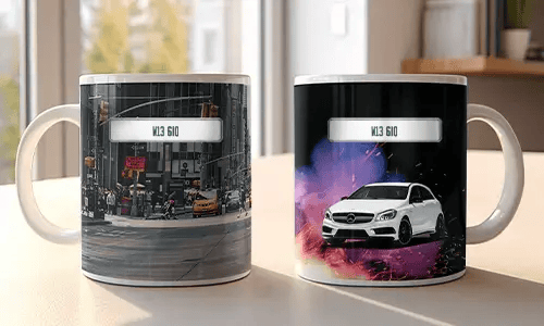 Two white mugs with car-themed prints: red BMW in urban setting, white Mercedes with sparks and colorful background