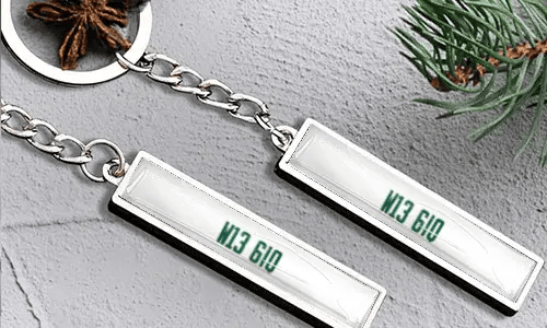 Metal keychain with number plate and flag detail