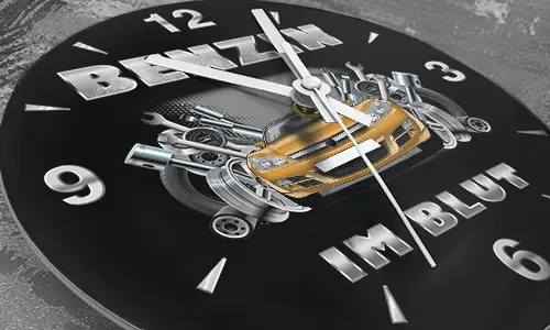 Wall clock with black sports car, pistons and wrenches, BENZIN IM BLUT text on black background
